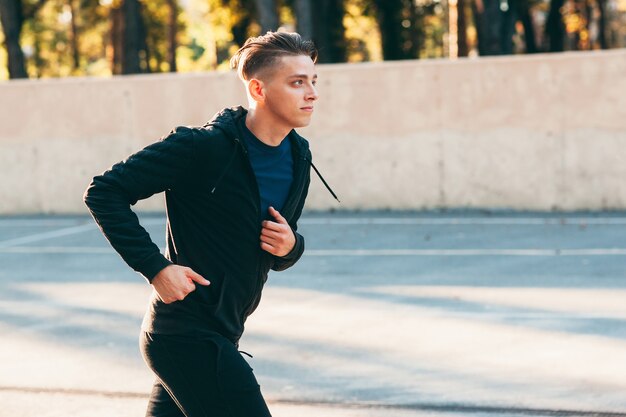 Handsome man jogging alone training for marathon