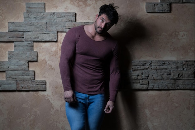 Handsome Man Leaning Against a Brick Wall