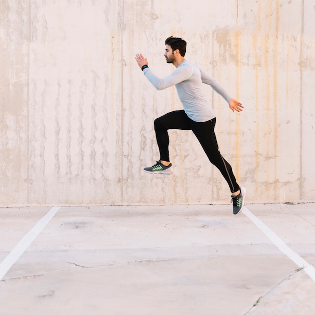 Handsome man leaping during training