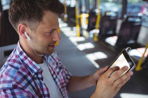 Handsome man listening music on digital tablet