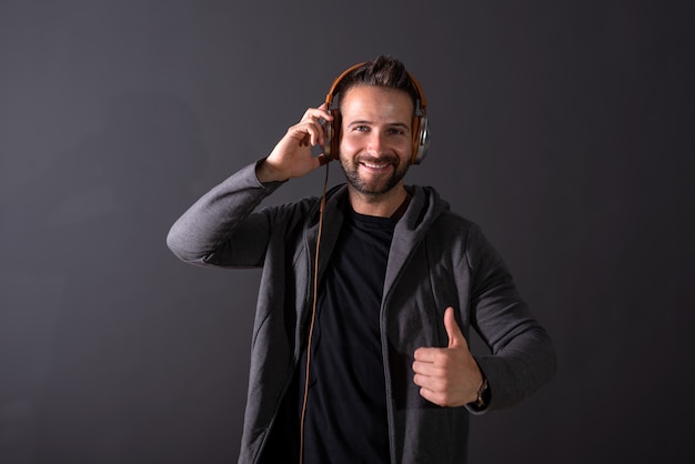 A handsome man listening to music and showing thumb up