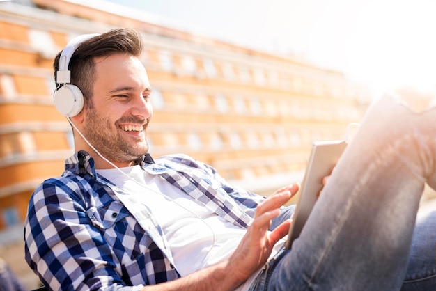 Handsome man listening to music on a smart phone