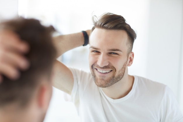 Handsome Man Looking in Mirror