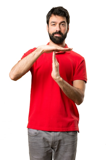 Handsome man making time out gesture