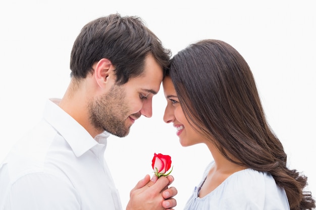 Handsome man offering his girlfriend a rose