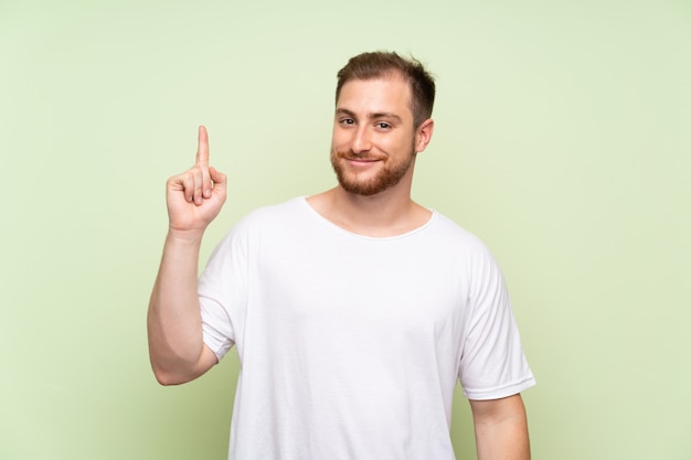 Handsome man pointing with the index finger a great idea