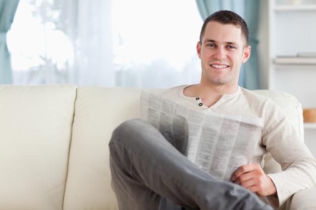 Handsome man reading a newspaper