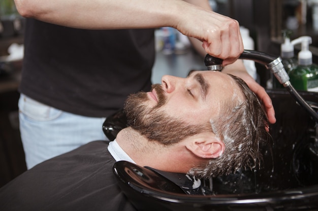 Handsome man relaxed in a barbershop