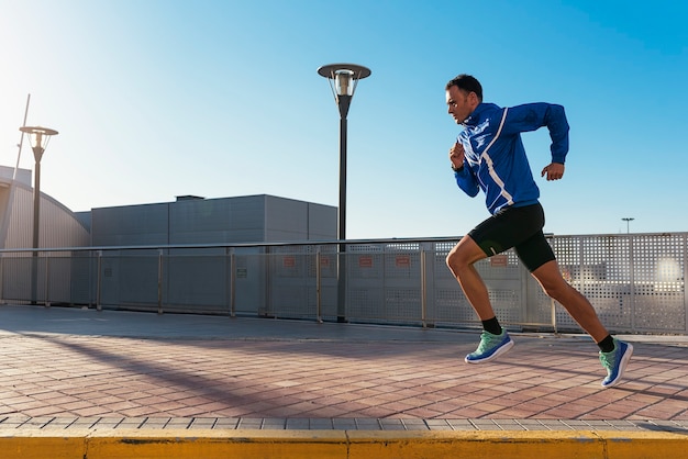 Handsome man running in the city. Fitness, workout, sport, lifestyle concept.