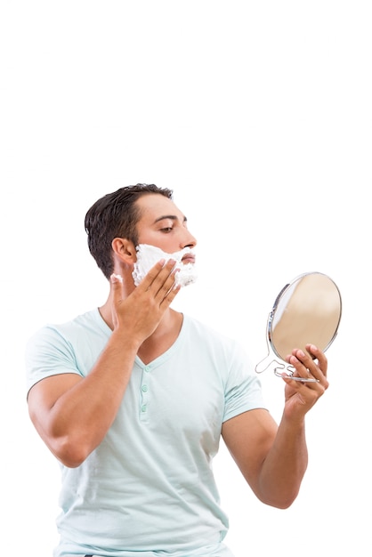 Handsome man shaving isolated on white