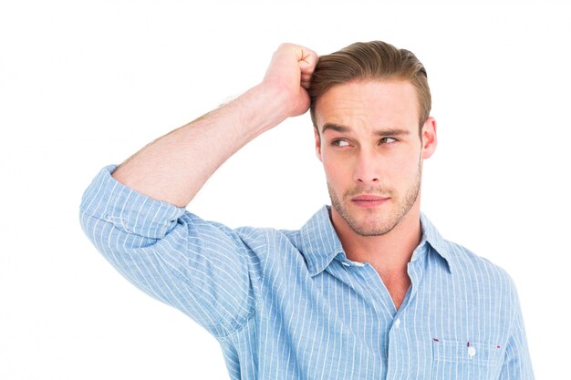 Handsome man in shirt thinking with hand on head