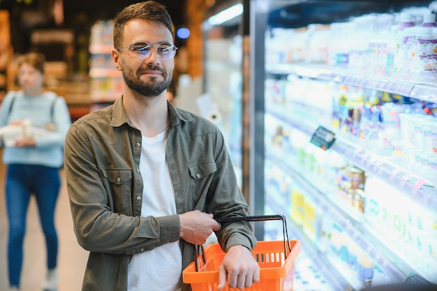 Handsome man shopping in a supermarket