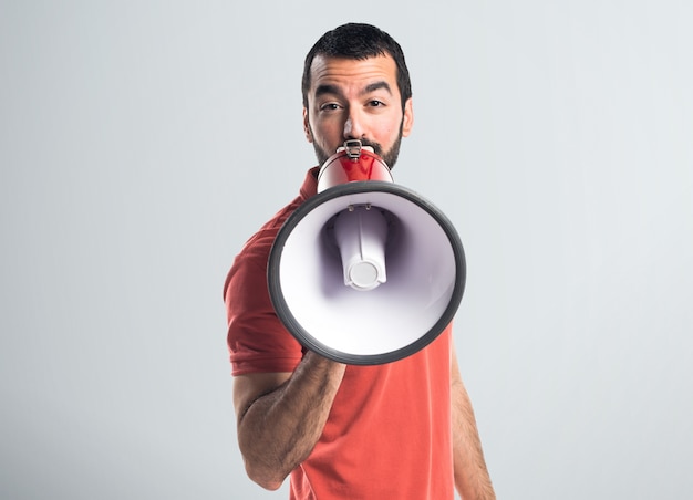 Handsome man shouting by megaphone