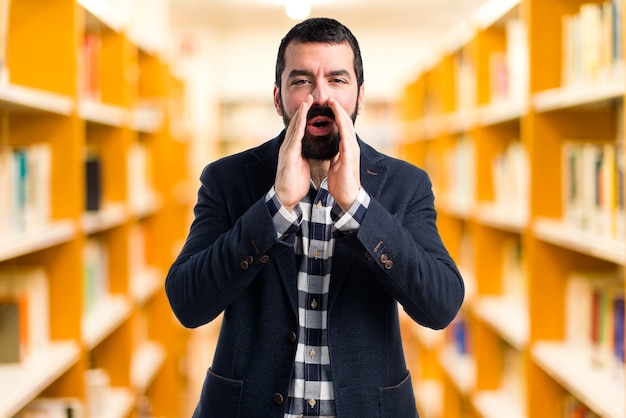 Handsome man shouting on unfocused background