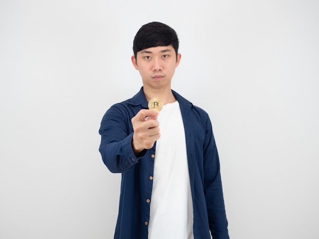 Handsome man show golden bitcoin in his finger with confident face on white background the digital money concept