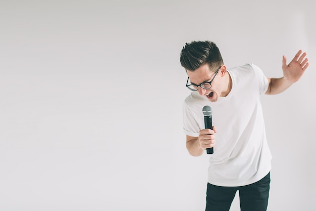 Handsome man singing to the microphone