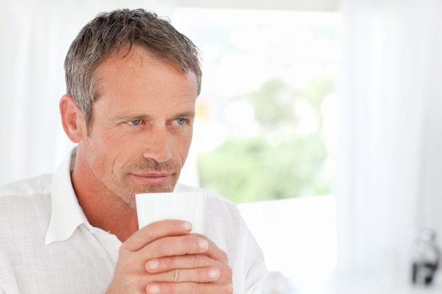 Handsome man smelling his coffee