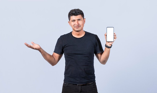 Handsome man smiling positive showing mobile phone blank screen with another hand palm open excited happy male holding smartphone