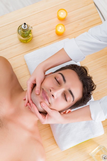 Handsome man during spa massaging session