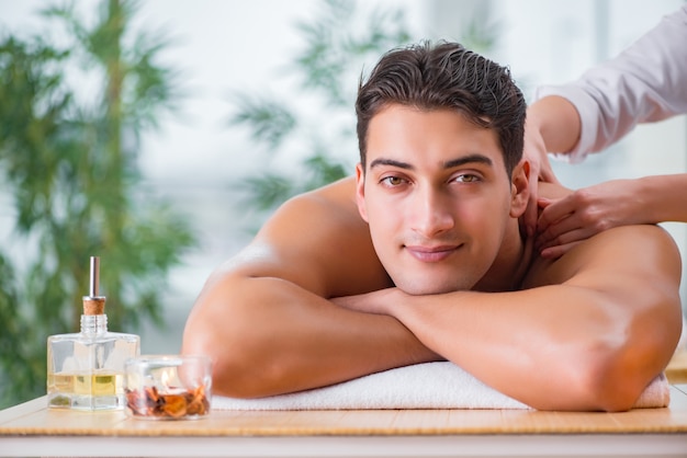 Handsome man during spa massaging session