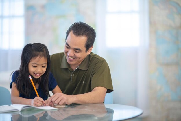 Handsome man spending time at home with his cute little daughter Happy Father's Day