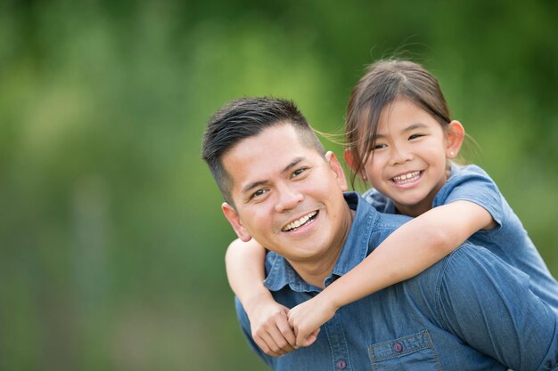 Photo handsome man spending time at home with his cute little daughter happy father's day