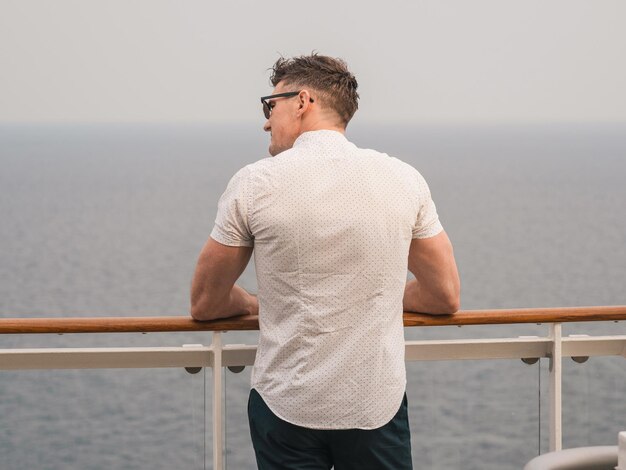 Handsome man standing on the empty deck