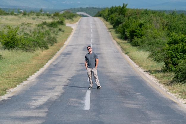 Handsome Man Standing Strong and Posing Outdoors at Street Highway