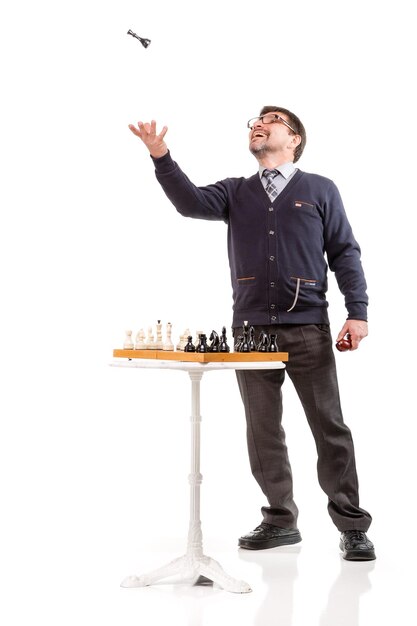 A handsome man in a suit and glasses with a pipe for smoking and chess White background