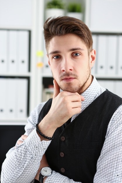 Handsome man in suit and tie stand in office