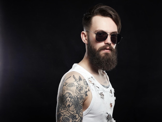 Handsome man in sunglasses tattoo