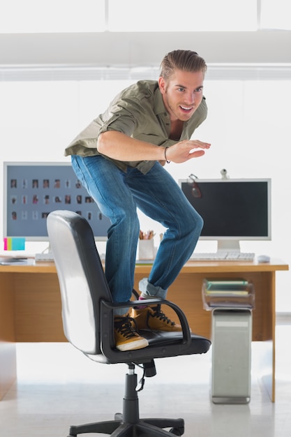 Handsome man surfing his office chair