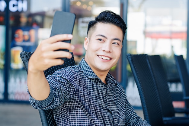 Handsome man taking selfie