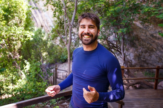 Handsome man on trail vacation smiling looking at camera. man smiling in the park.