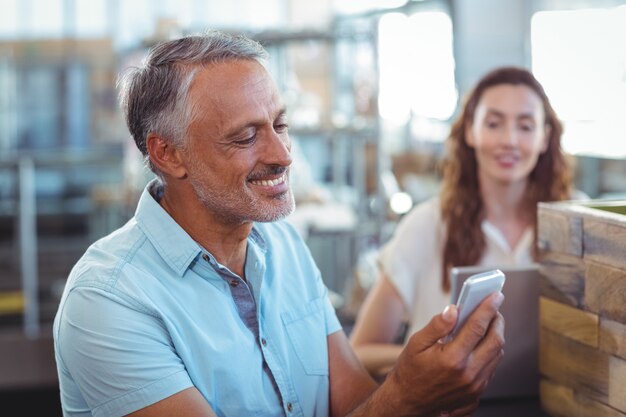 Handsome man using his smartphone