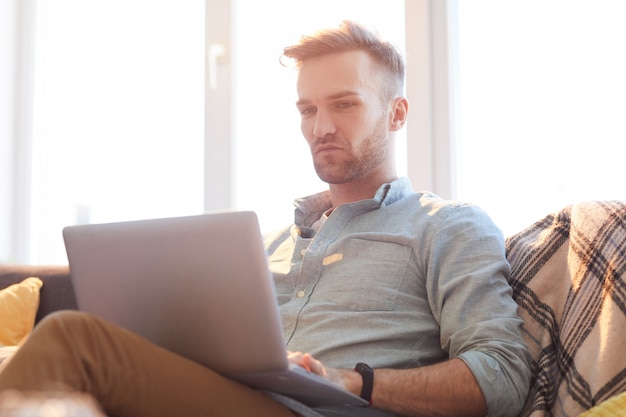 Handsome Man Using Laptop in Sunlight