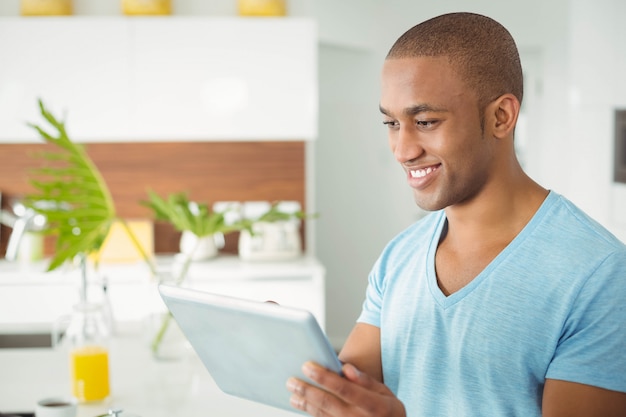 Handsome man using tablet in the kitchen