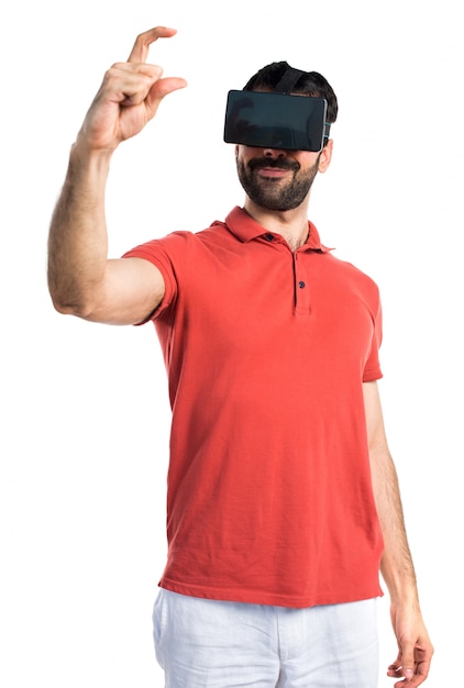 Handsome man using VR glassesa and holding something