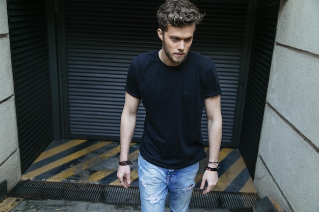 Handsome man walking against shutter