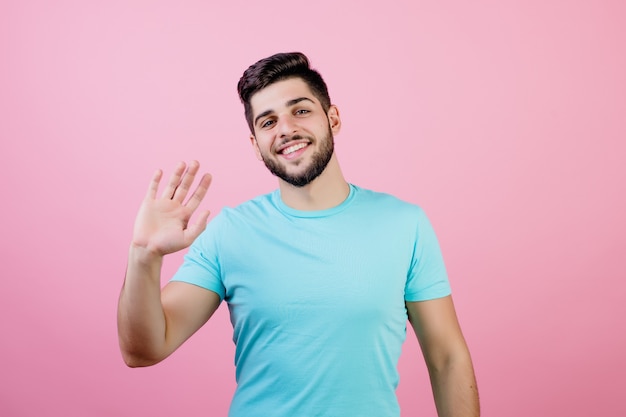 Handsome man waving hello with palm of hand