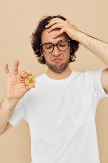 Handsome man in a white Tshirt with Bitcoin cryptocurrency isolated background