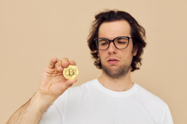 Handsome man in a white Tshirt with Bitcoin cryptocurrency Lifestyle unaltered