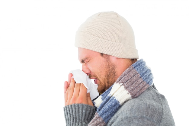 Handsome man in winter fashion blowing his nose