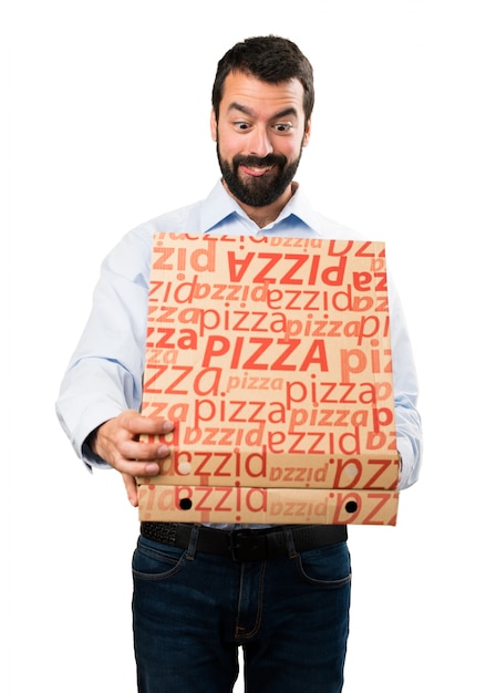 Handsome man with beard holding pizzas