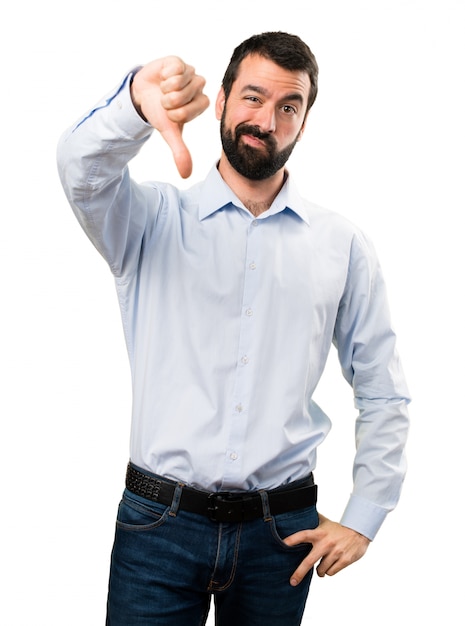 Handsome man with beard making bad signal