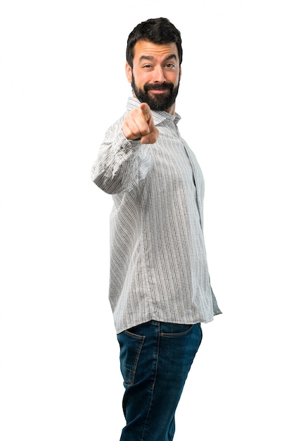 Photo handsome man with beard points finger at you