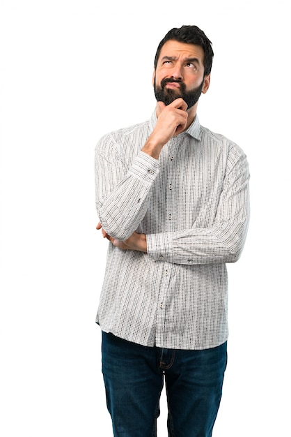 Handsome man with beard standing and thinking an idea