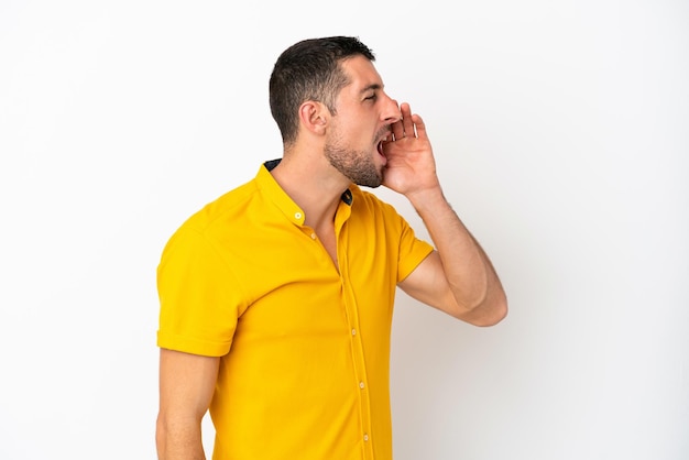 Handsome man with beard over white brick wall in zen pose