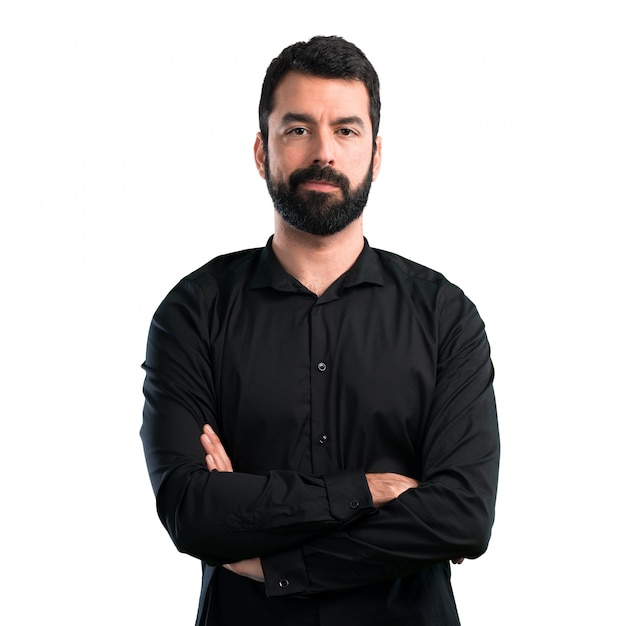 Handsome man with beard with his arms crossed on white background