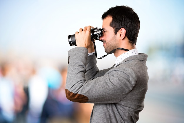 Handsome man with binoculars on unfocused background